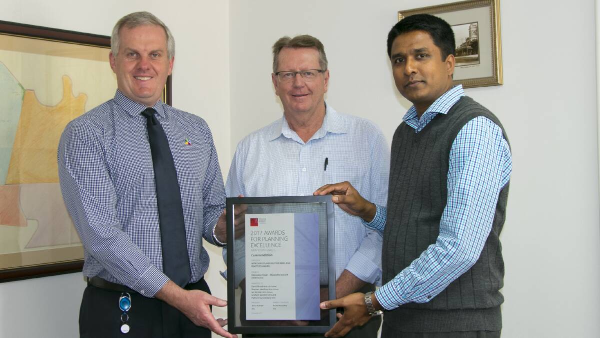WELL DONE: Muswellbrook Shire Council general manager Steve McDonald congratulates strategic planning consultant Graham Gardner and acting manager planning and environment Pathum Gunasekara on the award.