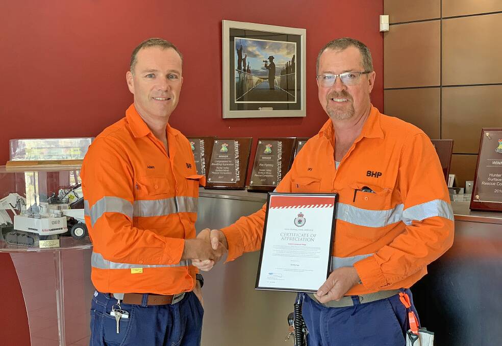 CHPP technician and Glendonbrook NSW Rural Fire Service volunteer Gary Thomas and Mt Arthur Coal GM Adam Lancey celebrate the Muswellbrook mine being named a Supportive Employer by the NSW RFS.
