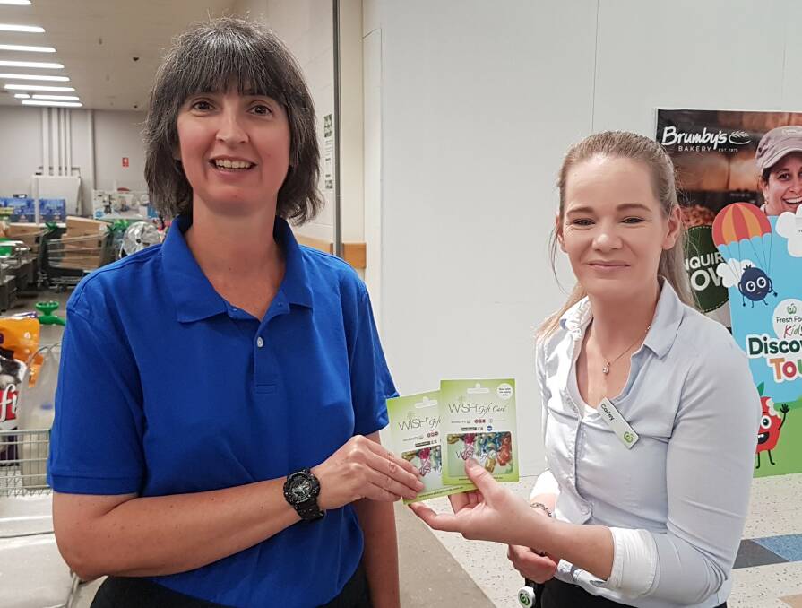 Elisha Carter receives her prize from Woolworths Muswellbrook assistant store manager Carley Brennan. 