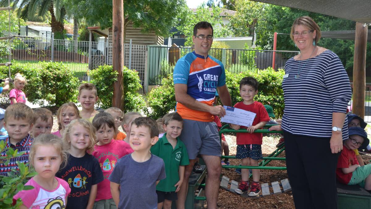 THANKS: Muswellbrook Pre-School pupils, including Jack Mitchell, and director Kelly Constable presented a $300 cheque to local Great Cycle Challenge participant Jared Mitchell on Tuesday.