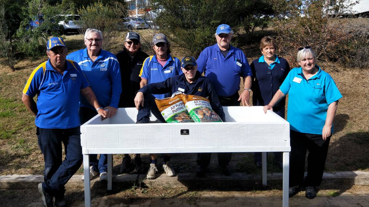 MEN AT WORK: Members of the Muswellbrook Men’s Shed deliver the garden bed to staff at Muswellbrook District Hospital’s Weidman Wing.