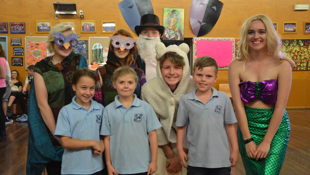 HAPPY: Muswellbrook Public School pupils Miley Cutrupi, Zali Hogan and Connor Smith with a few Muswellbrook High School drama students.