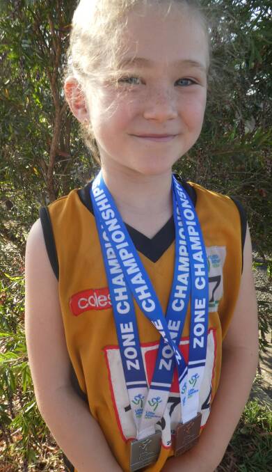SUCCESS: Aberdeen under-7 athlete Penny Brochtrup with her medallions from the Hunter Zone Championships.