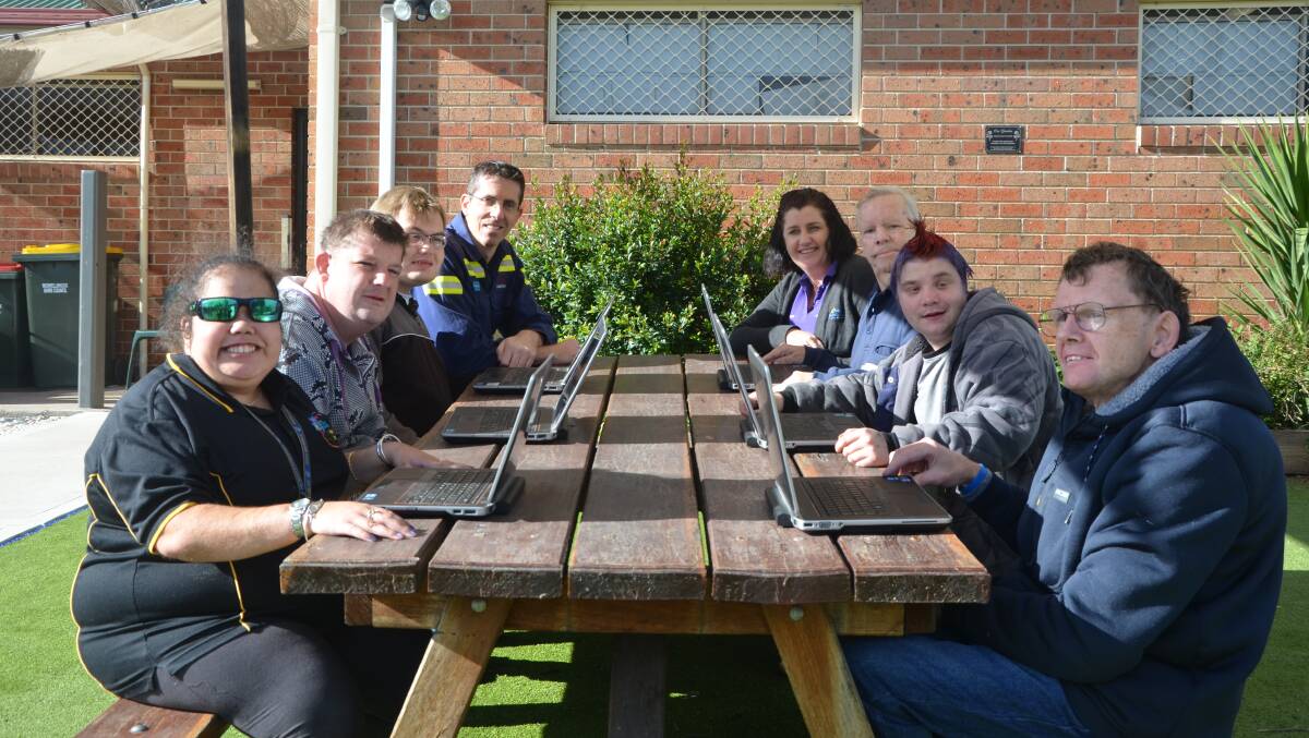 TECH SAVVY: Bengalla Mine IT administrator Jonathon Walsh and Endeavour Group Australia Muswellbrook regional coordinator Sally Pereira with a few of the clients and their “new” laptops.