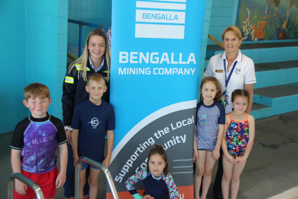 IN THE SWIM OF THINGS: Bengalla business administration trainee Taylah Moore and Muswellbrook Public School principal Joan Stephens with students, front, Dean Farmer, Callum Gilbey, Isla Googe, Isabella Reynolds and Kenzi Lesley.