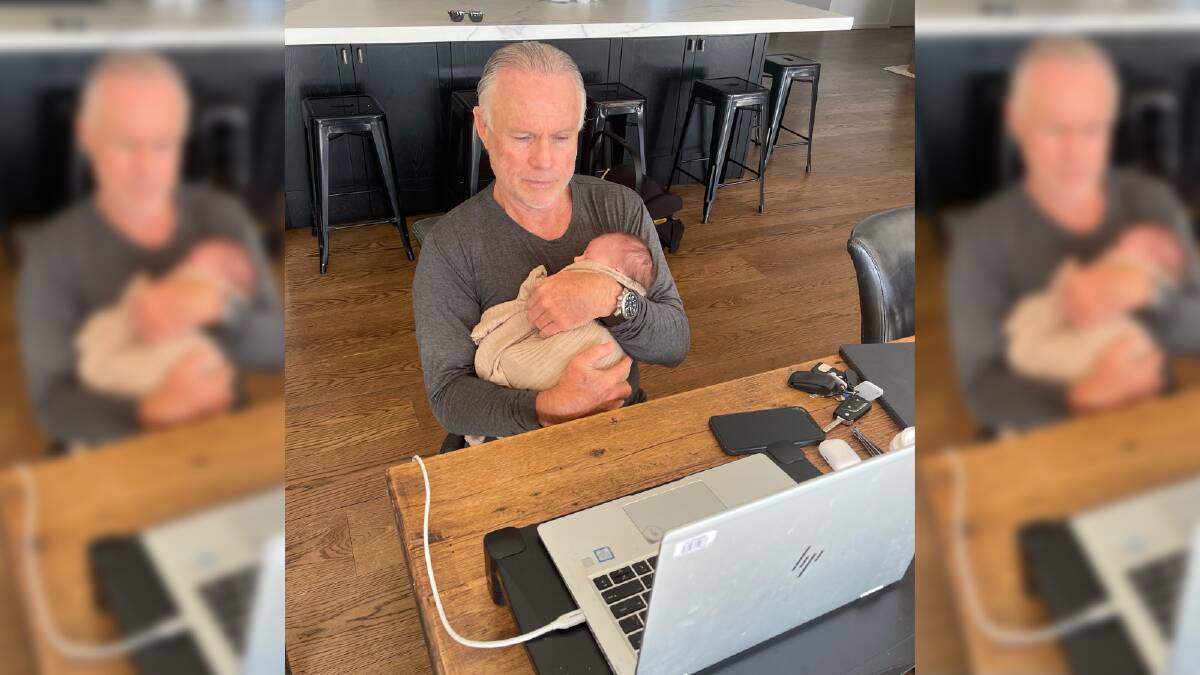 Feeling At Home: Nib chief executive Mark Fitzgibbon with his first granddaughter Charlie, while on a Zoom call with his executive team. 