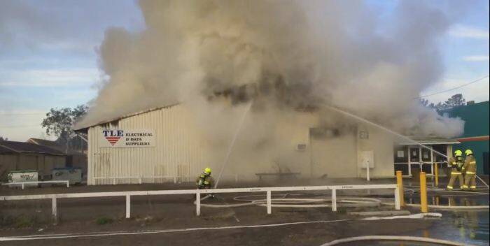 Fire fighters working to put down the blaze in the TLE warehouse.