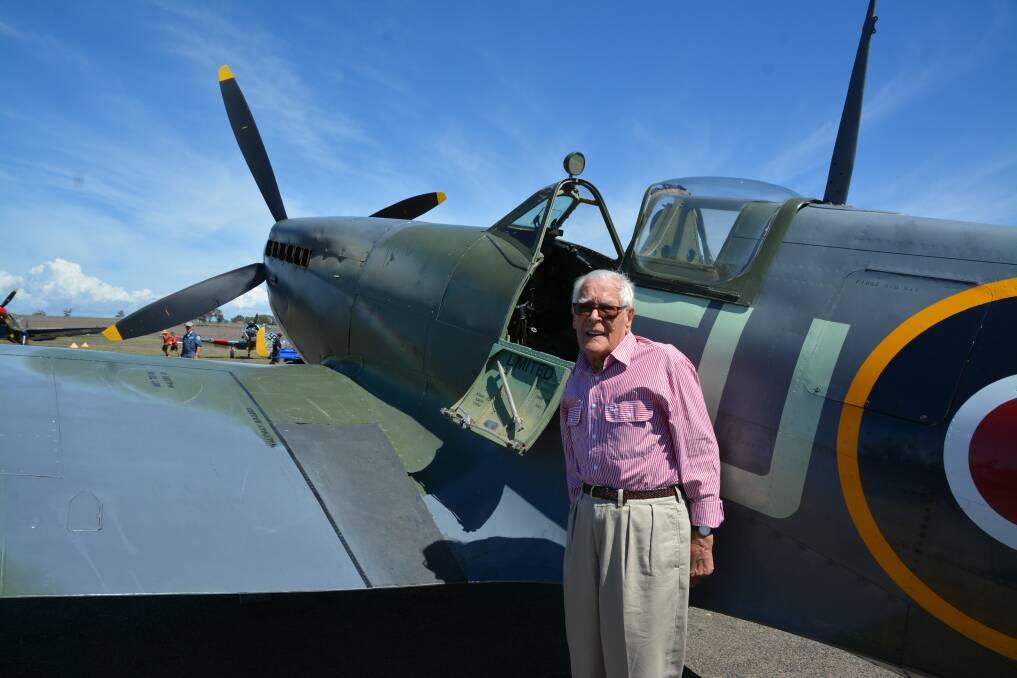 Former pilot of Spitfires, Lyslie Roberts who served in WWII standing infront of a Spitfire.