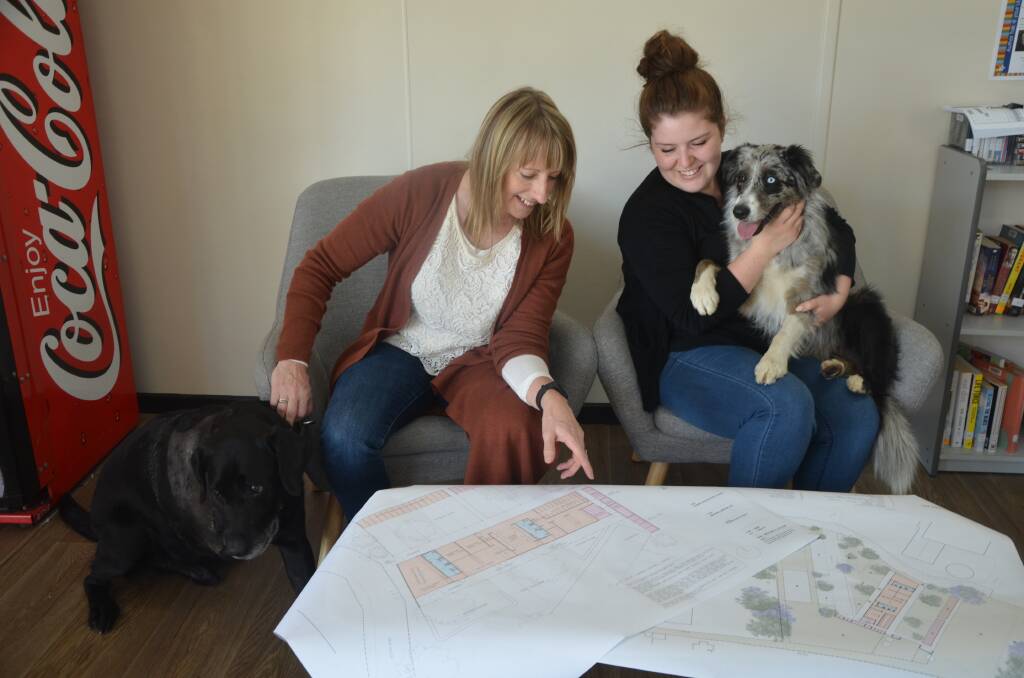 PLANNING FOR PUPS: Council staff Sharon Pope and Melanie Meadows look at the new Animal Care Facility plans with the help of Toby and Ivy.