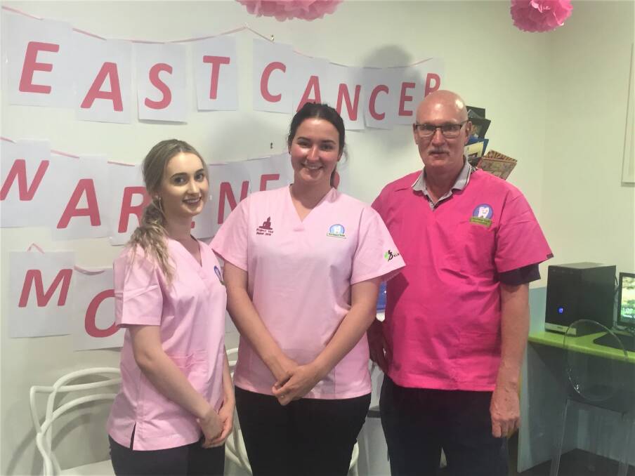 COMMUNITY CARE: Brittany Farmilo, Samantha Seagrave and Paul O'Neill dressed in pink scrubs for Breast Cancer Awareness Month.