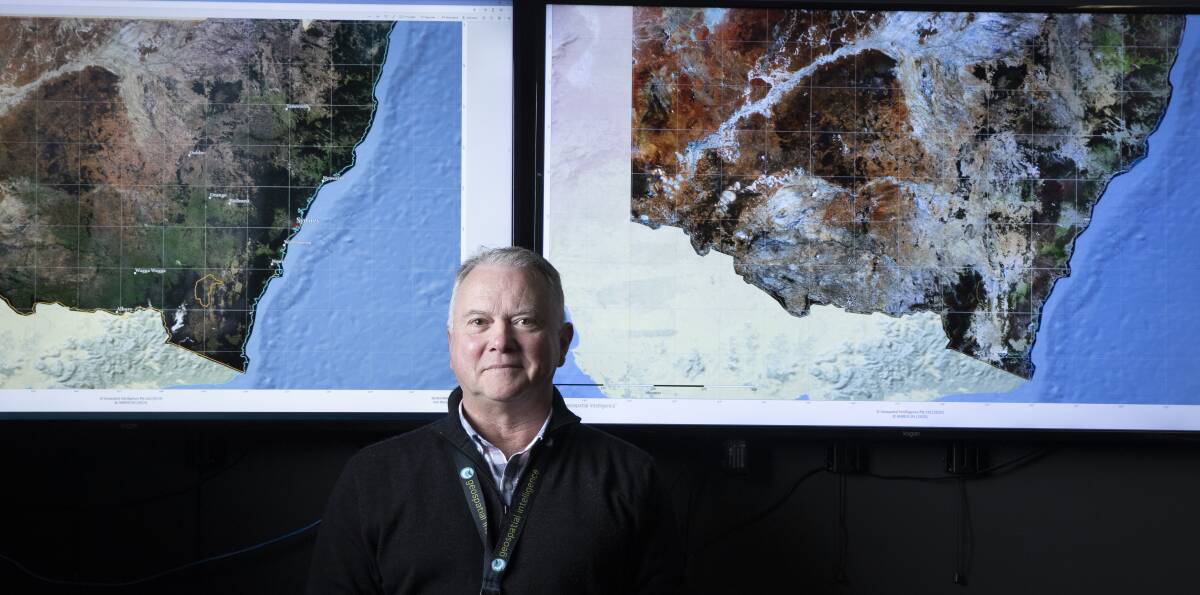 Geospatial Intelligence chief executive Rob Coorey stands in front images comparing bush coverage before and after the devastating bushfire season. Picture: Sitthixay Ditthavong
