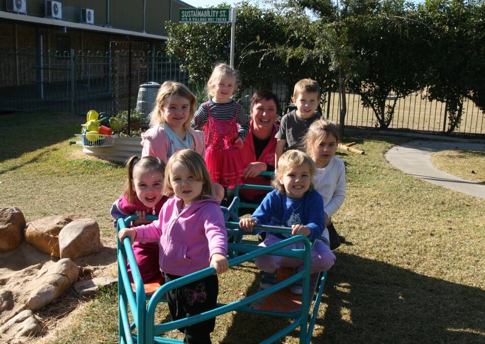 EXTENSION PLAN: Maddison, Bonnie, Jazmyn, Benedicte, Rory, Ebony and Rose with nominated supervisor Nicole McKenzie at the Denman Childcare Centre where a new extension is planned. 