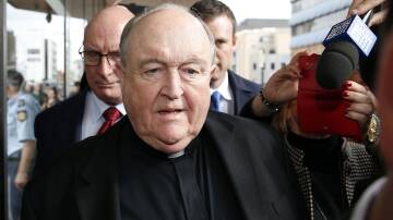 Calls: Archbishop Philip Wilson leaves Newcastle Courthouse on Tuesday after he was sentenced to 12 months jail for concealing the child sex offences of a Hunter priest. Picture: Darren Pateman.