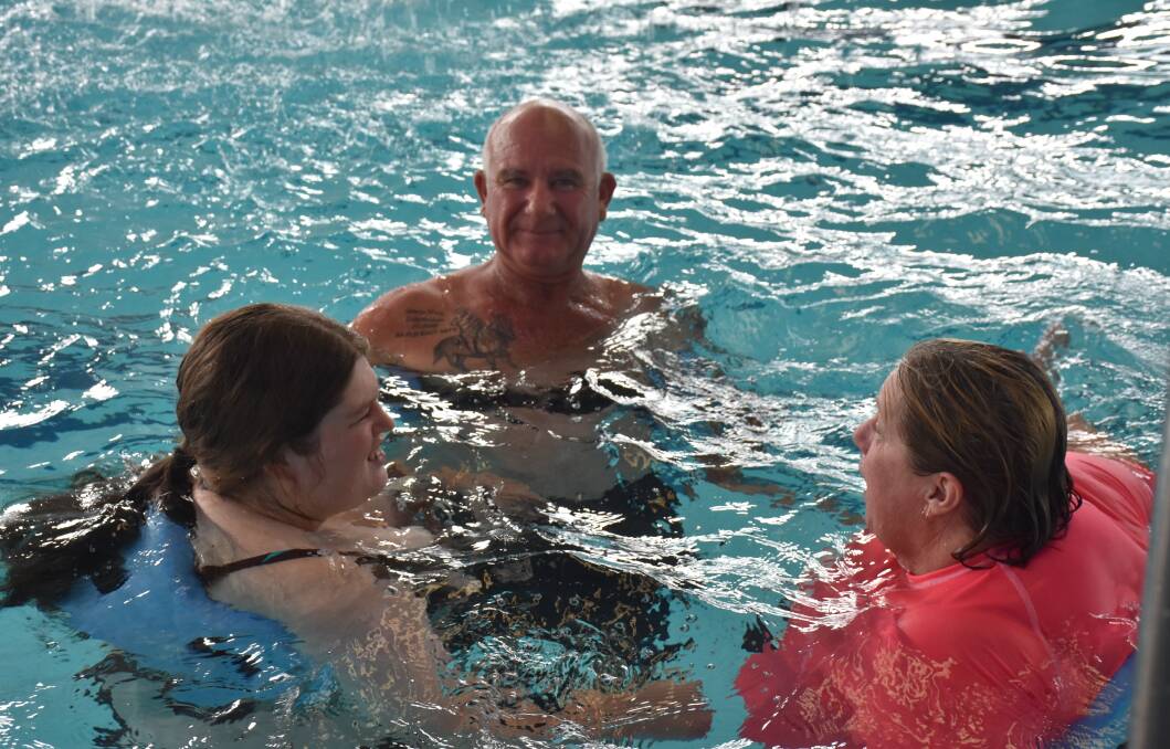 POOL FUN: Merriwa's Tess Orton, carer Mark Wilton, and swimming teacher Sandra Chandler on Wednesday.