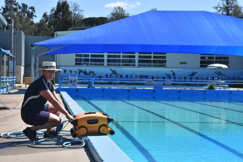 MAKING A SPLASH: Muswellbrook Aquatic and Fitness Centre senior lifeguard Joscelyn Pender with the pool cleaner, ahead of the outdoor pool opening this weekend.