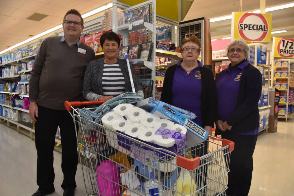 GOOD EFFORT: Muswellbrook Coles store manager Phil Winkler, grocery grab winner Betty Erickson with her full trolley,  and Lioness Club of Muswellbrook members Wilma holmes and Val McDonald.