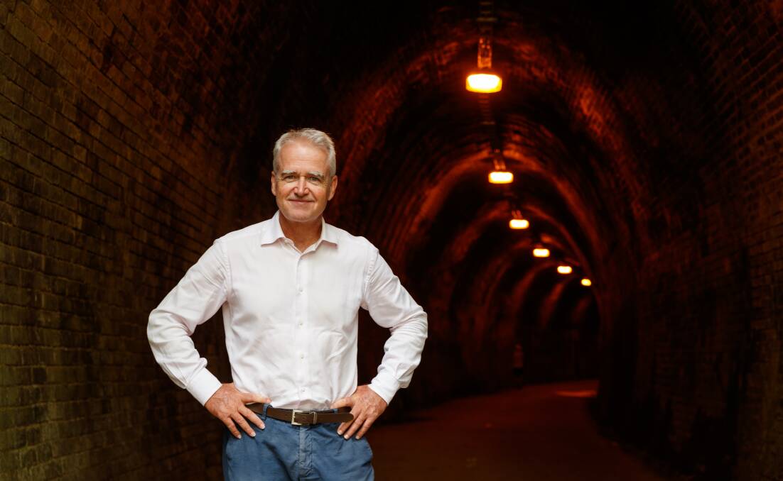 Writer Scott Bevan at the southern entrance to Redhead Tunnel on the Fernleigh Track. Picture: Max Mason-Hubers 