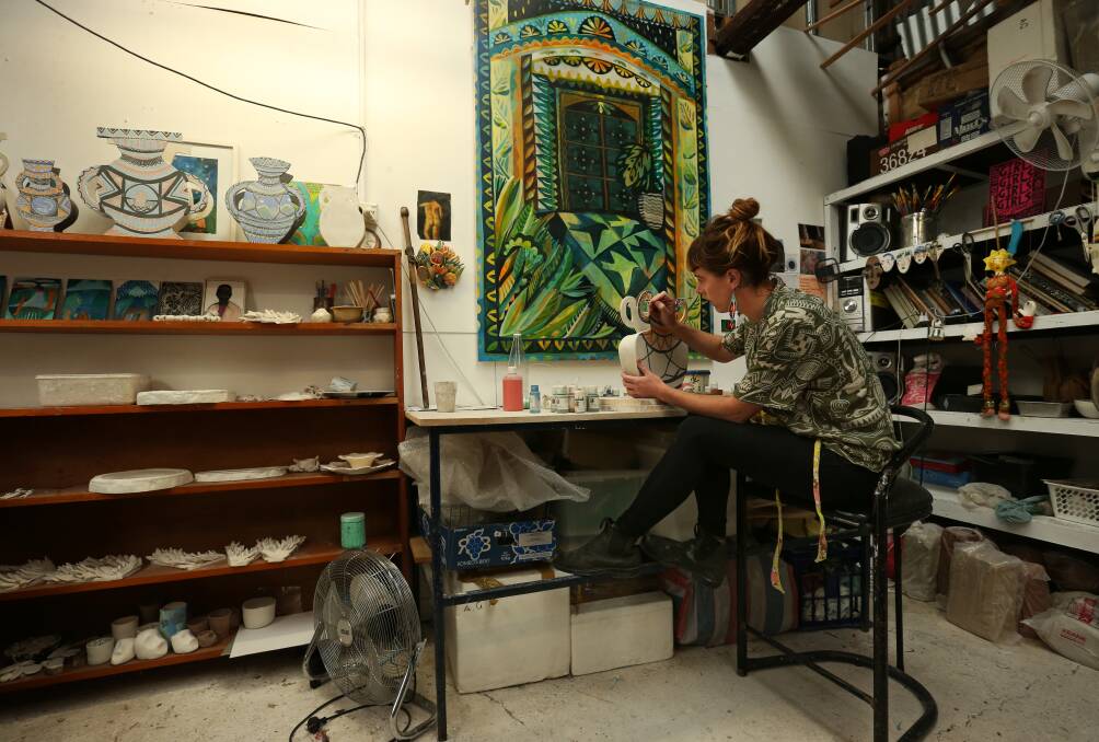 Ellie Hannon working on ceramics in her studio. Picture: Simone De Peak