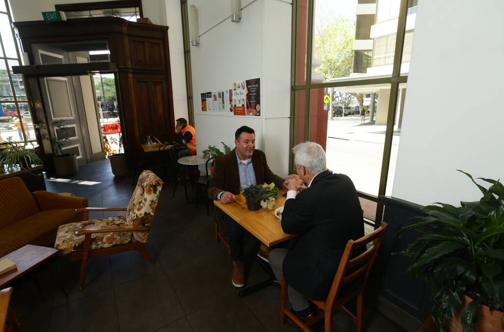 EARLY SHIFT: Breakfast radio announcer Richard King talks with Scott Bevan at Momo Wholefood cafe. Picture: Jonathan Carroll