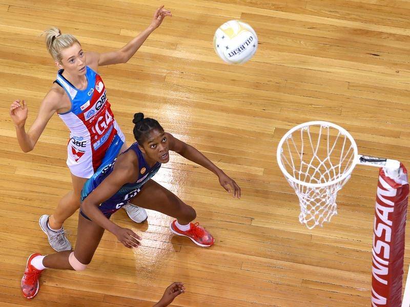 NSW Swifts' Helen Housby shoots over Melbourne Vixens' Kadie Ann Dehany in the netball prelim final.