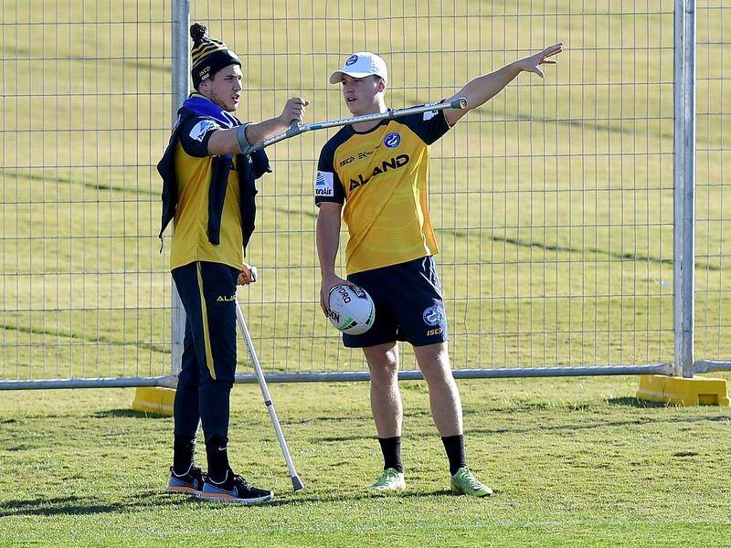 Injured halfback Mitchell Moses gives his fill in Jai Field some pointers at Parramatta training.