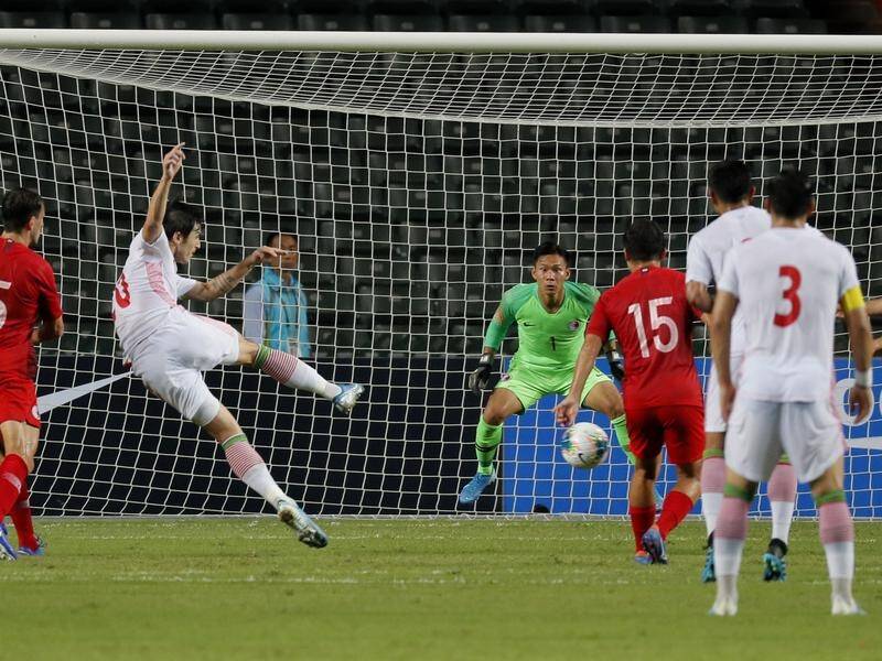 Sardar Azmoun (second left) fires home Iran's opener in the World Cup qualifer against Hong Kong.