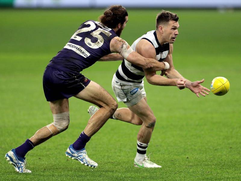 Geelong forward Shaun Higgins (r) will contest his fine for staging against Fremantle.