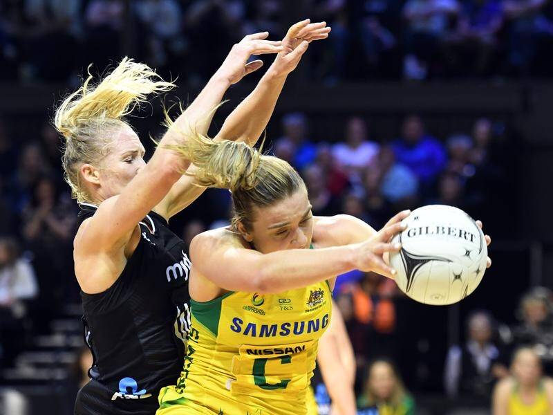 Australia's Liz Watson (right) tries to keep the ball from evergreen New Zealand star Laura Langman.
