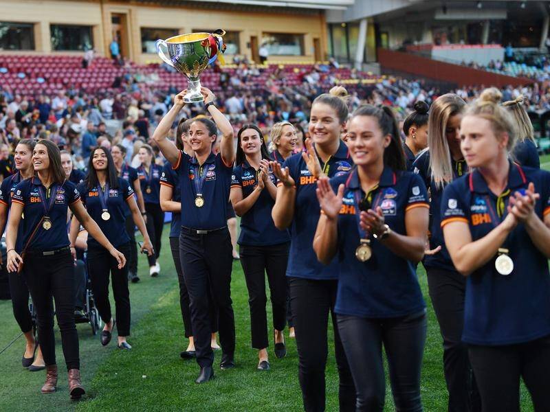 Adelaide players parade the AFLW premiership trophy after their 2019 triumph.