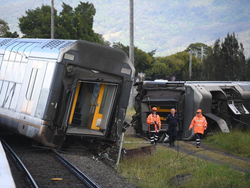 A passenger train derailed after hitting a van left on a level crossing at Kembla Grange, NSW.