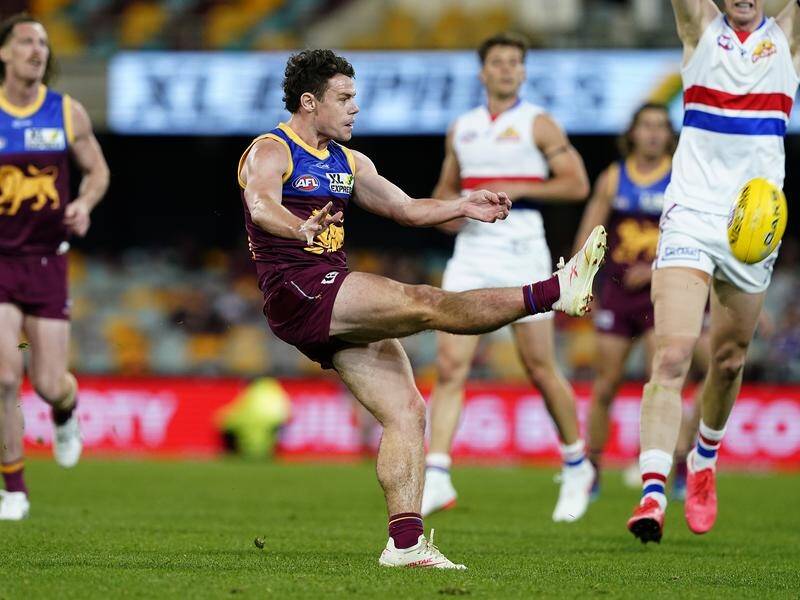 Lachie Neale kicks a goal for the Lions in their 24-point win over the Bulldogs on Saturday.