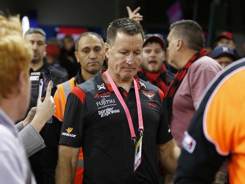 Bombers head coach John Worsfold runs the gauntlet of Essendon fans after the loss to St Kilda.
