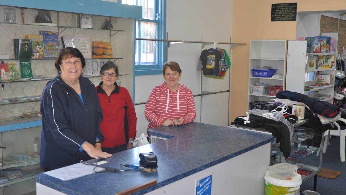 BUSINESS AS USUAL: Carol O’Brien, Carmel Frankender and Lyn Paton prepare the Muswellbrook St Vincent de Paul shop for its re-opening on Monday.