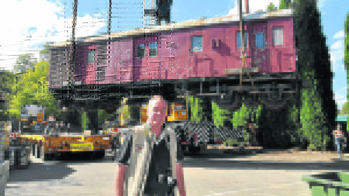 DREAM COME TRUE: The Railway Hotel owner Greg Smith was delighted to have the retired rail carriage lifted by crane to his car park.