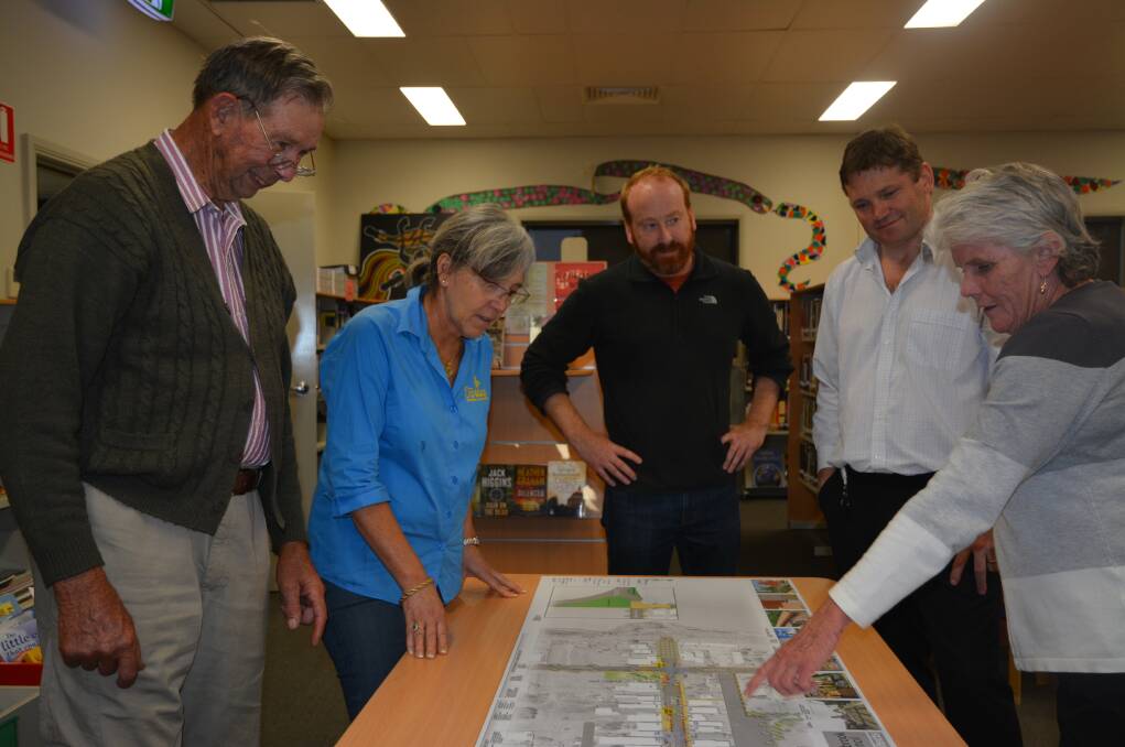 INTRIGUED: Jeff Wolfgang, Laura Cora-Macolino, Muswellbrook mayor Martin Rush, acting director of environmental service Eddie Love, and secretary of Denman Chamber of Commerce Maureen Dalton looking at the plan on Wednesday. 
