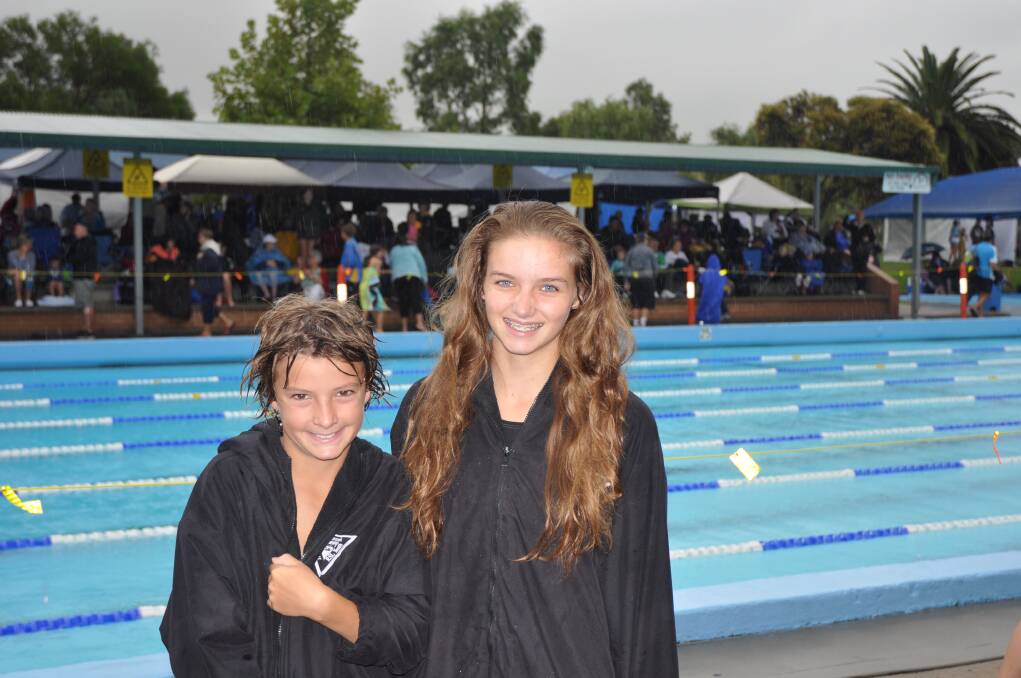 BRAVING THE ELEMENTS: Muswellbrook Amateur RSL Youth Swimming Club members Joseph Hamson, 9, and Maddi Hamson, 15, before the start of the competition.