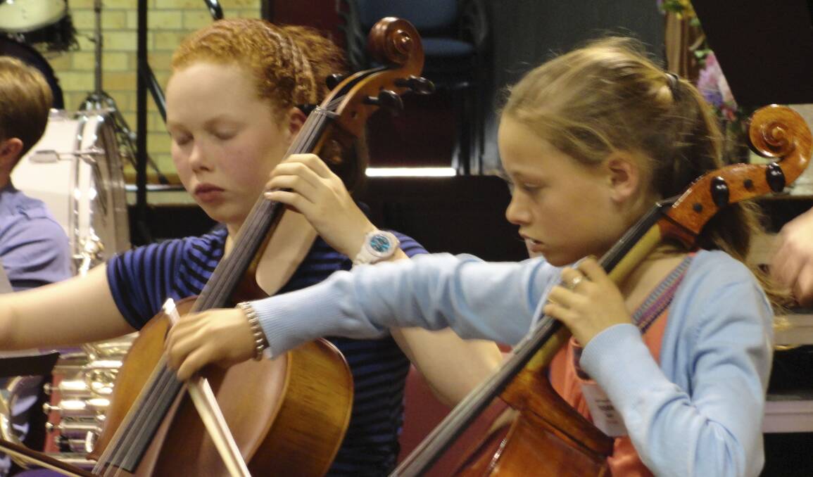 JOYFUL EXPERIENCE: Dominica Leaver (left) and Indyana Taylor develop their skills at the annual Orchestra Camp.